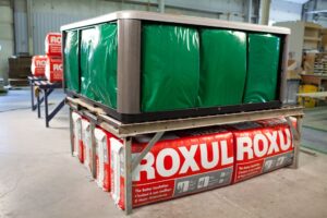 Stacked ROXUL insulation bags under spa shell