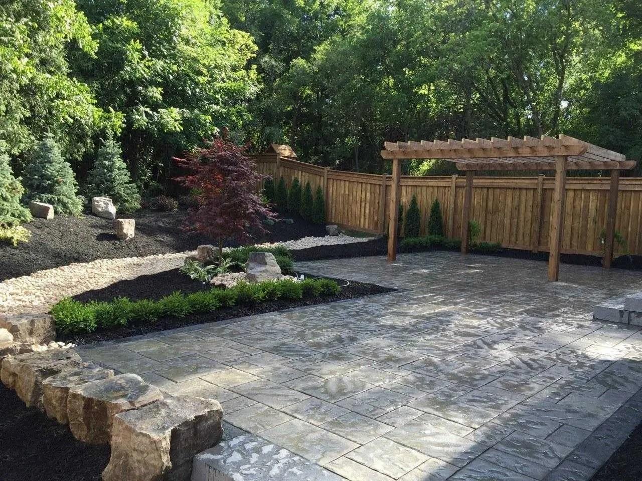 A beautiful lawn area with greenery and tile work